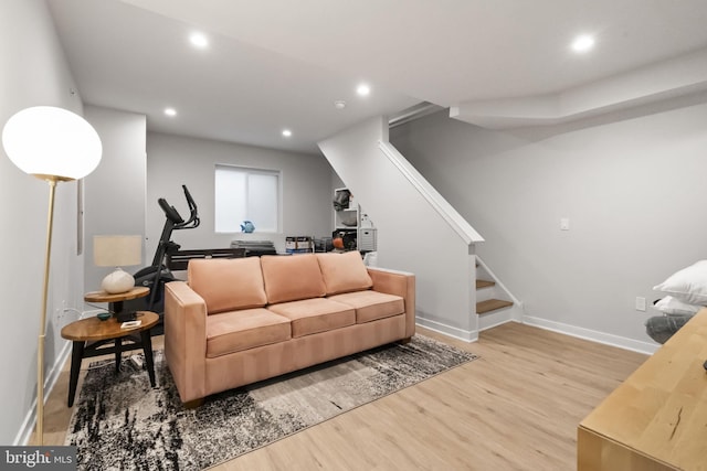 living room with stairway, recessed lighting, wood finished floors, and baseboards