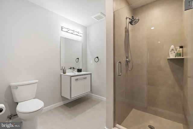 bathroom with a stall shower, toilet, and baseboards