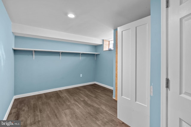 basement with dark wood-type flooring and baseboards