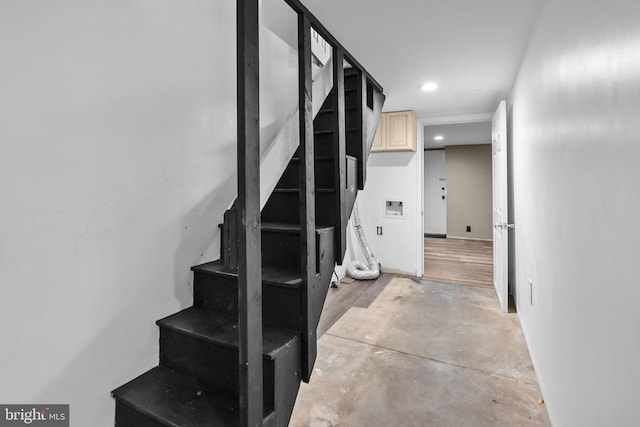 stairs with concrete flooring and recessed lighting