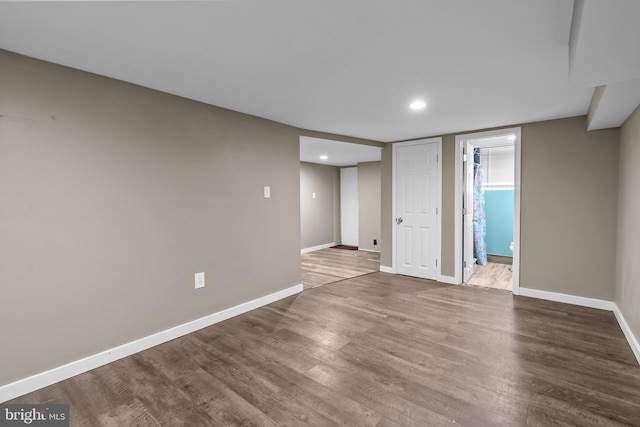 spare room with recessed lighting, wood finished floors, and baseboards