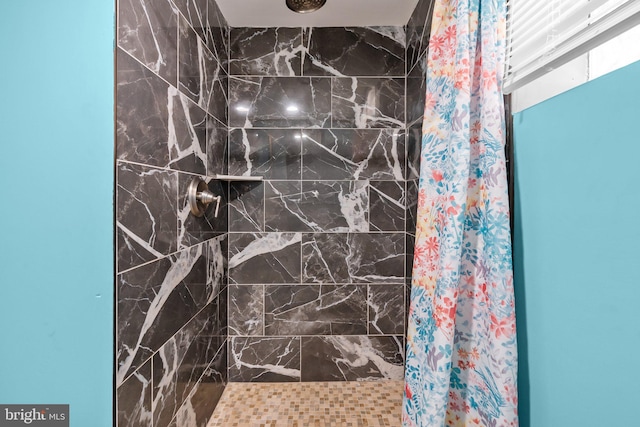 full bathroom with a tile shower