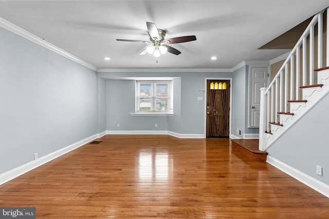 entrance foyer with baseboards, wood finished floors, and ornamental molding