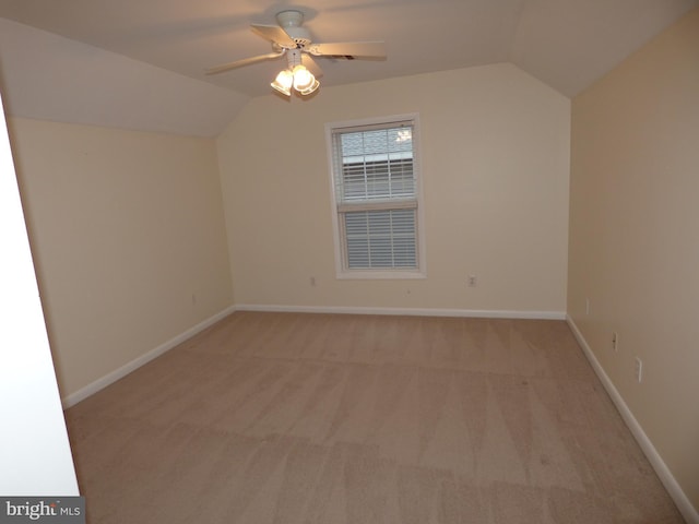 bonus room with lofted ceiling, light carpet, ceiling fan, and baseboards