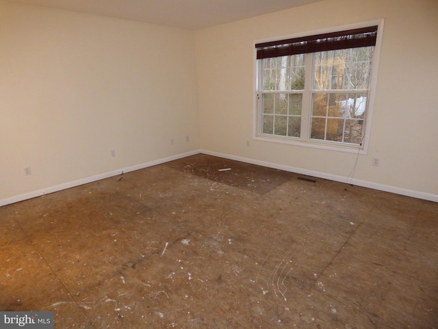 unfurnished room with visible vents and baseboards