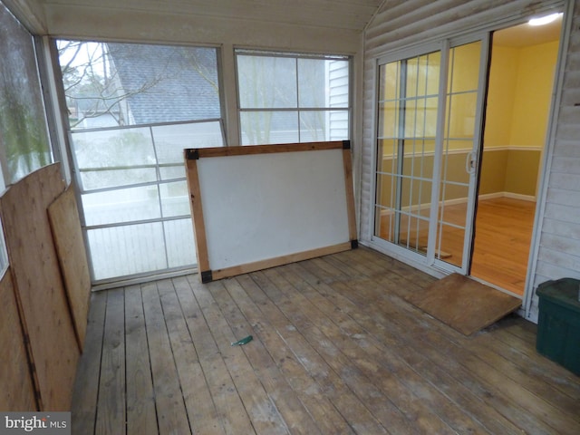 unfurnished sunroom with lofted ceiling