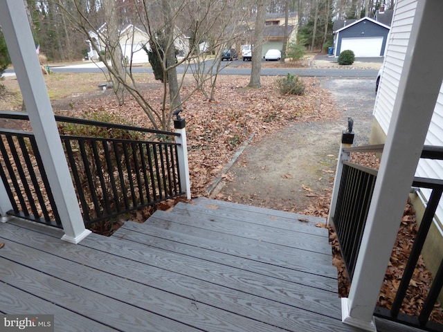 wooden deck featuring a garage