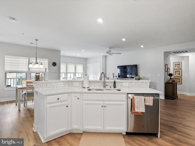 kitchen featuring a wealth of natural light, open floor plan, a sink, and stainless steel dishwasher