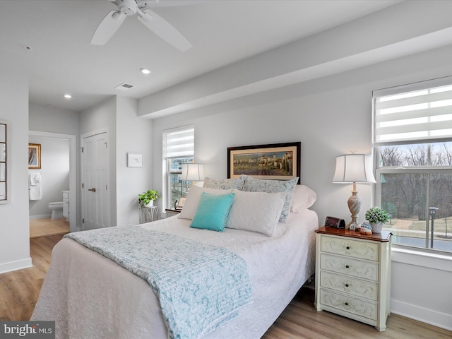 bedroom featuring wood finished floors, visible vents, and baseboards