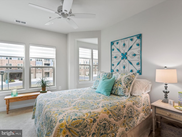 carpeted bedroom featuring visible vents and a ceiling fan