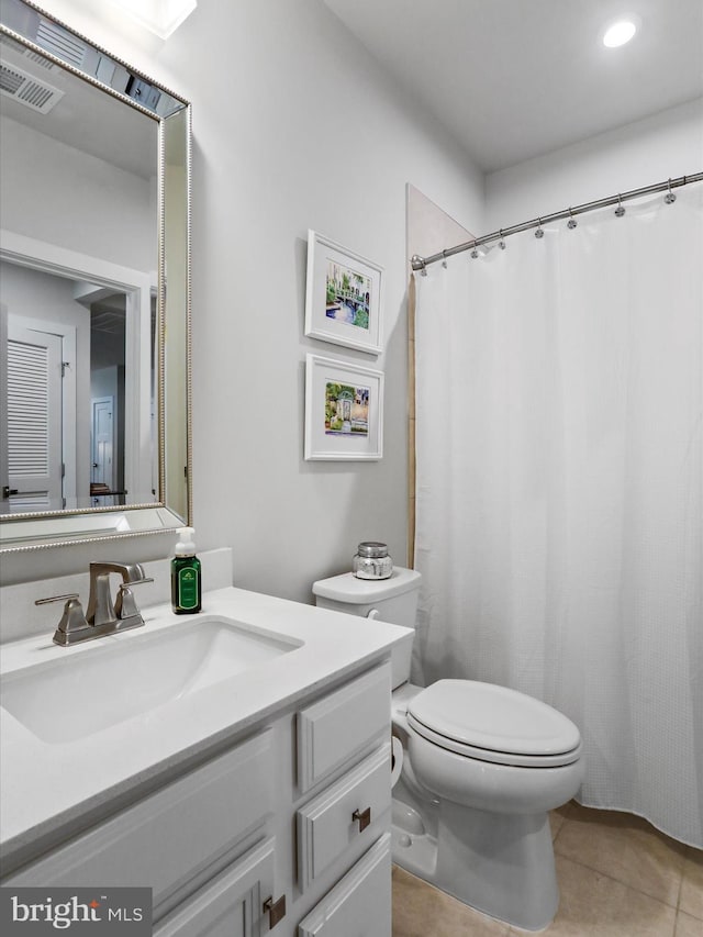 full bathroom featuring visible vents, vanity, toilet, and tile patterned floors