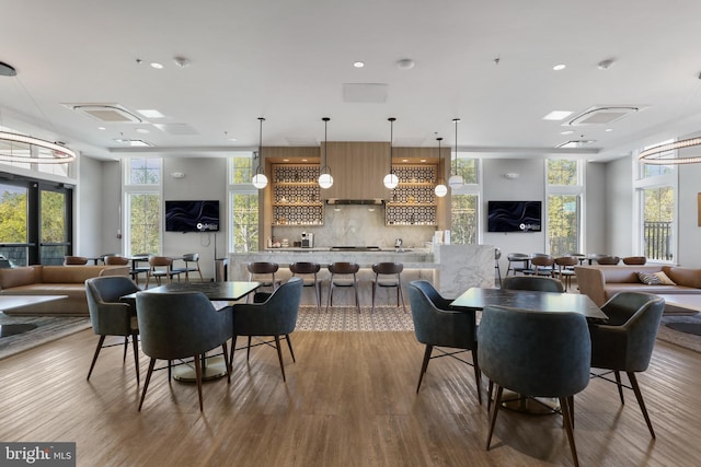 dining area with wood finished floors and recessed lighting