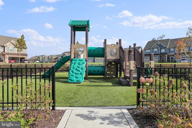 community playground with a residential view, fence, and a yard