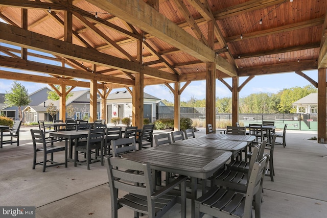 view of patio featuring outdoor dining area and fence