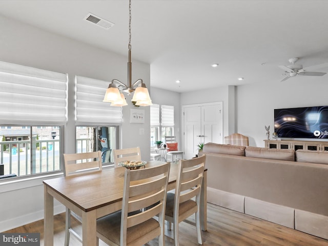 dining space featuring a wealth of natural light, wood finished floors, visible vents, and recessed lighting