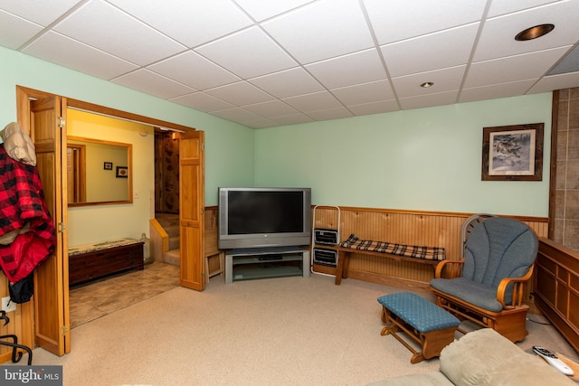 sitting room with carpet floors and a drop ceiling