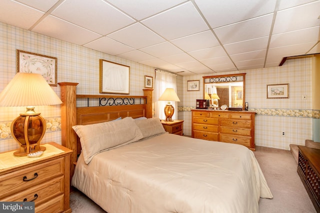 carpeted bedroom featuring a paneled ceiling and wallpapered walls