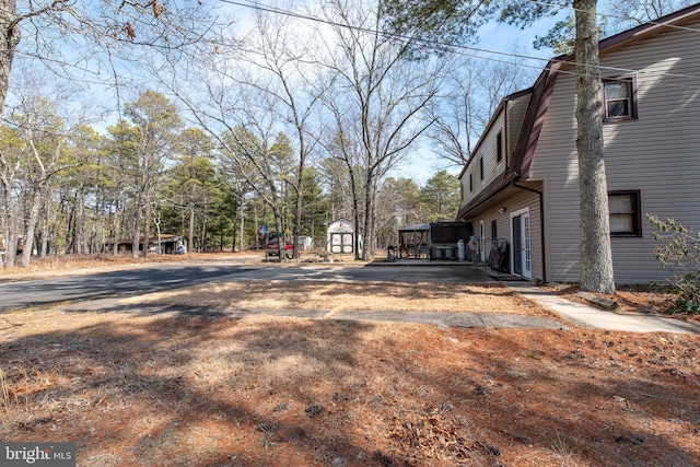 view of home's exterior featuring a storage shed and an outdoor structure