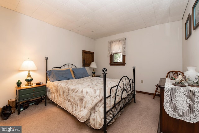 bedroom featuring carpet and baseboards