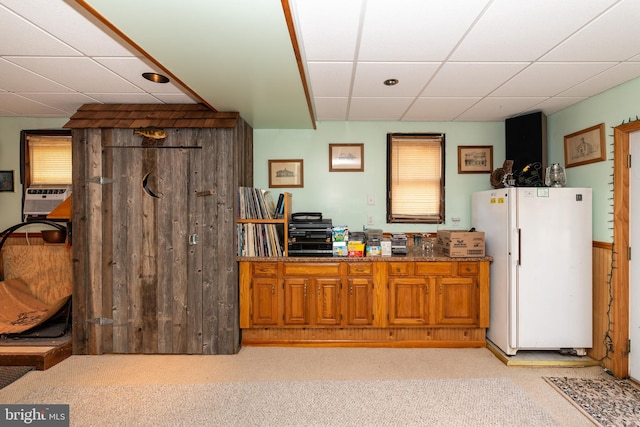 bar with freestanding refrigerator, light carpet, a paneled ceiling, and cooling unit