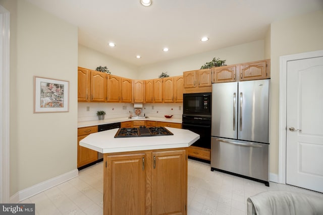 kitchen with light floors, a center island, light countertops, black appliances, and recessed lighting