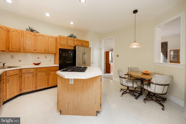 kitchen with black appliances, light floors, light countertops, and a center island