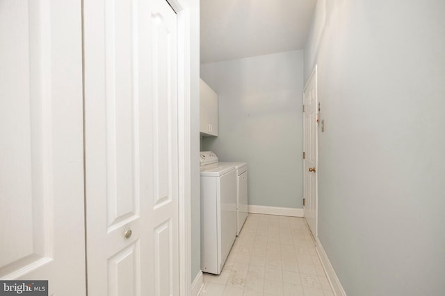 laundry room featuring baseboards, cabinet space, and washer and dryer