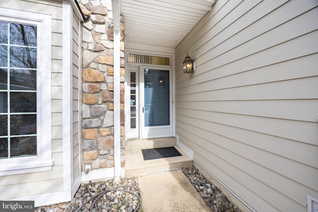 property entrance with stone siding