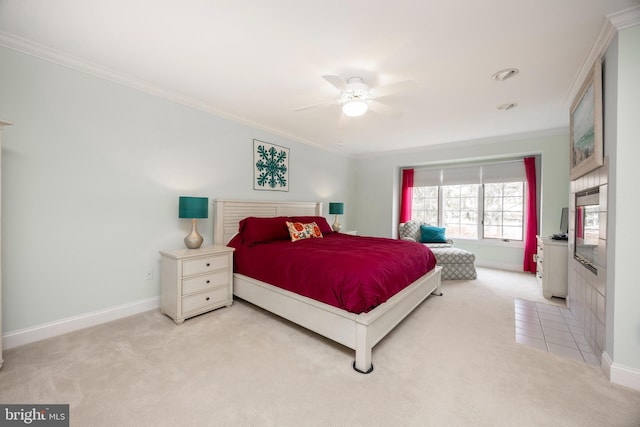 carpeted bedroom featuring a ceiling fan, crown molding, and baseboards