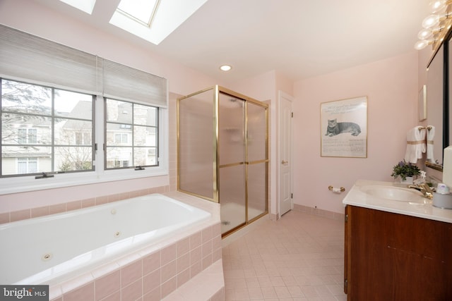 bathroom featuring a skylight, a shower stall, a whirlpool tub, and tile patterned floors