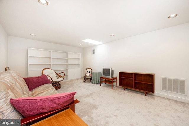 sitting room with a skylight, carpet flooring, visible vents, and recessed lighting