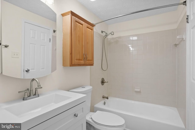 full bath featuring a textured ceiling, tub / shower combination, vanity, and toilet