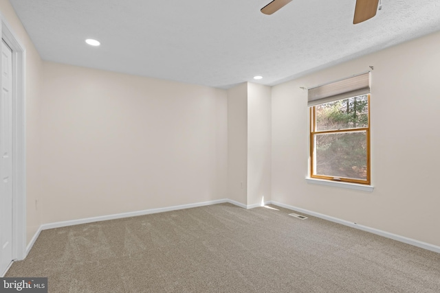 empty room featuring visible vents, baseboards, carpet flooring, and recessed lighting