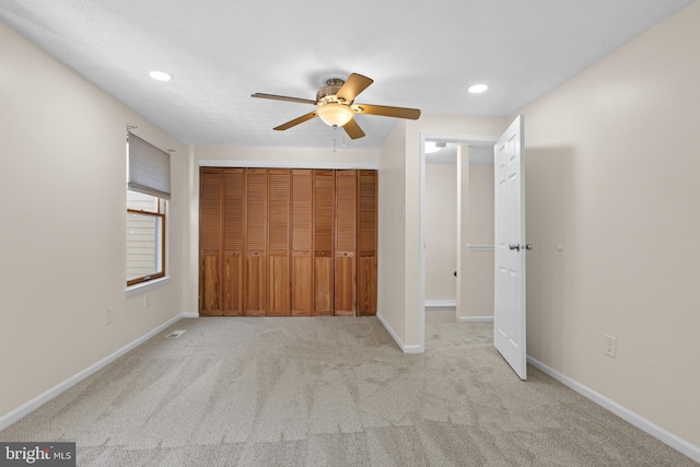 unfurnished bedroom featuring recessed lighting, carpet flooring, a ceiling fan, baseboards, and a closet