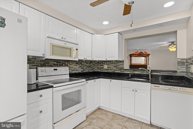 kitchen featuring backsplash, a ceiling fan, white cabinets, a sink, and white appliances