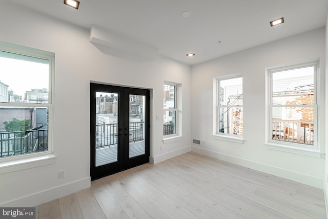 entrance foyer featuring visible vents, baseboards, light wood-style flooring, french doors, and recessed lighting