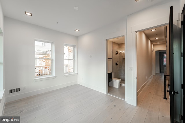 unfurnished bedroom with connected bathroom, recessed lighting, visible vents, baseboards, and light wood-style floors