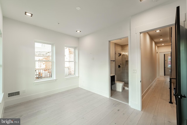 unfurnished bedroom featuring light wood-style flooring, recessed lighting, visible vents, and baseboards