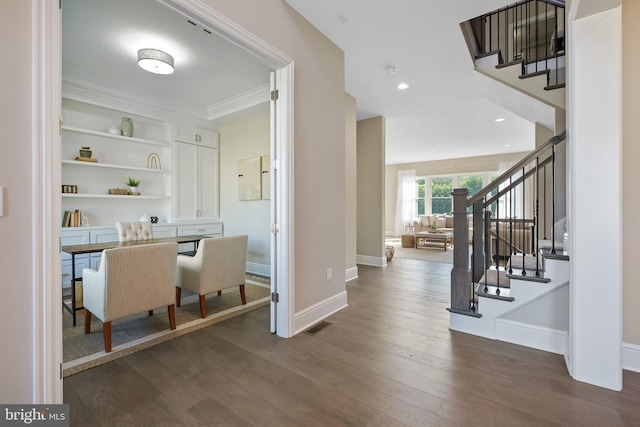 bar featuring dark wood-type flooring, stairway, and baseboards