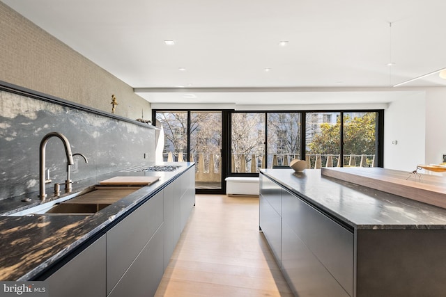 2510 Virginia Ave NW Unit 512-S, Washington, DC 20037 - kitchen with modern cabinets, backsplash, stainless steel gas cooktop, gray cabinets, and recessed lighting