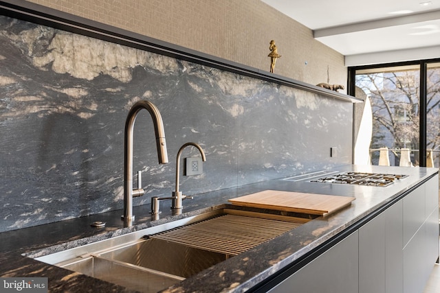 2510 Virginia Ave NW Unit 512-S, Washington, DC 20037 - kitchen view of backsplash, stainless steel gas cooktop, and dark stone counters