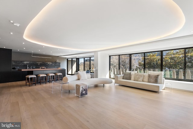 2510 Virginia Ave NW Unit 512-S, Washington, DC 20037 - living room featuring a tray ceiling, wood finished floors, plenty of natural light, and recessed lighting