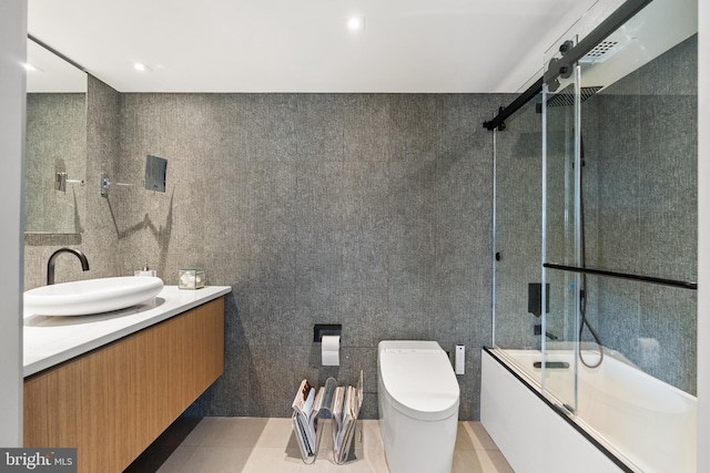 2510 Virginia Ave NW Unit 512-S, Washington, DC 20037 - bathroom featuring vanity, tile walls, and bath / shower combo with glass door