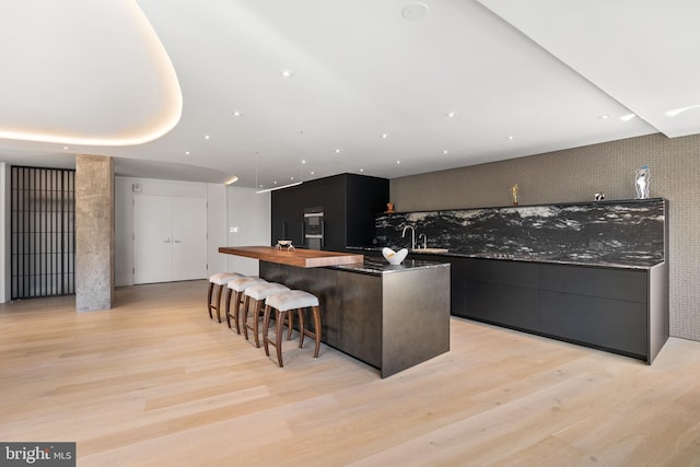 2510 Virginia Ave NW Unit 512-S, Washington, DC 20037 - kitchen featuring a spacious island, light wood finished floors, wooden counters, modern cabinets, and recessed lighting