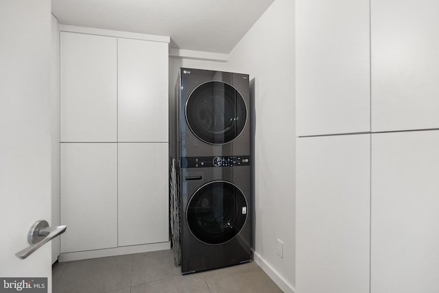 2510 Virginia Ave NW Unit 512-S, Washington, DC 20037 - laundry area with stacked washer and clothes dryer and light tile patterned flooring