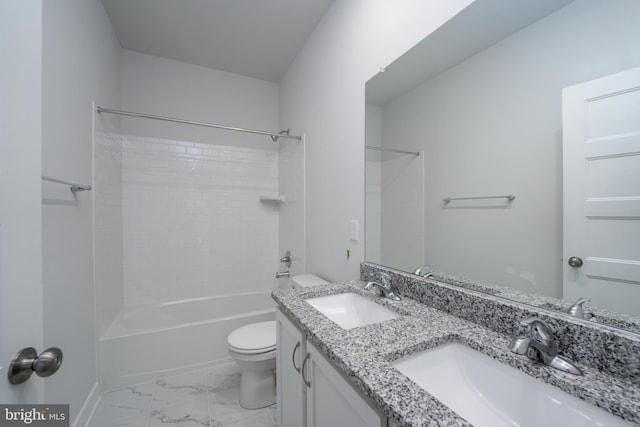 bathroom featuring marble finish floor, shower / tub combination, a sink, and toilet