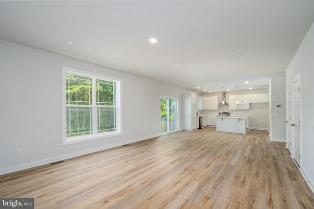 unfurnished living room featuring baseboards, recessed lighting, visible vents, and light wood-style floors