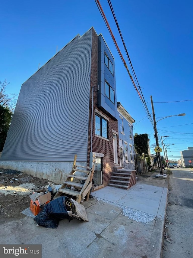 view of side of home with brick siding