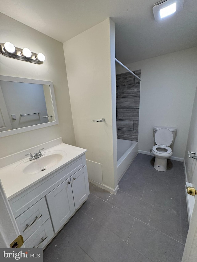 full bath featuring tile patterned flooring, toilet, bathing tub / shower combination, vanity, and baseboards