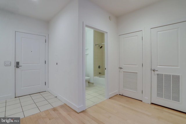 interior space with visible vents, light wood-style flooring, and baseboards